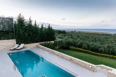 a swimming pool with a view of the ocean at Villa Kudos in Maleme