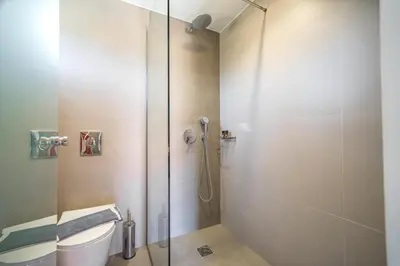 a bathroom with a shower stall and a toilet at Lofos Village Chania in Agia Marina Nea Kydonias