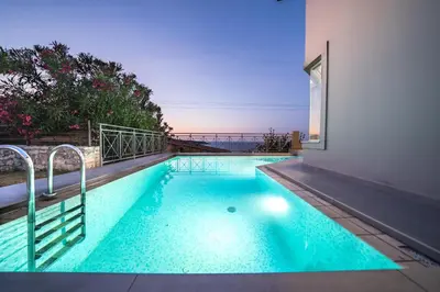 a swimming pool in the middle of a building at Lofos Village Chania in Agia Marina Nea Kydonias