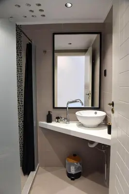 a bathroom with a white sink and a mirror at Galini Studios & Apartments-Adults only in Sougia