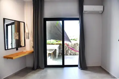 a room with a sliding glass door with a table at Galini Studios & Apartments-Adults only in Sougia