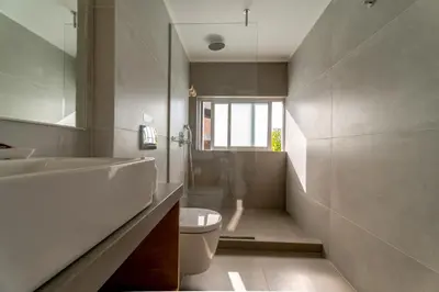 a bathroom with a sink and a toilet and a mirror at Lotus Hotel Apartments in Kato Daratso