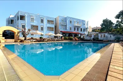 a large swimming pool in front of some buildings at Giorgi's Blue Apartments in Kalathas