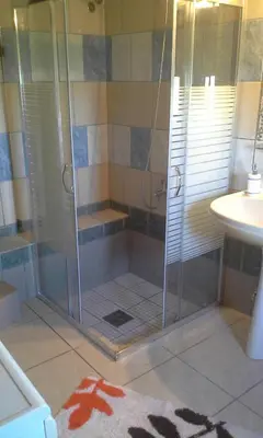 a shower with a glass door in a bathroom at Traditional House Koukounara in Kissamos