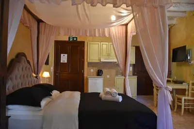 a teddy bear sitting on top of a bed at Odos Oneiron Boutique Hotel in Chania Town