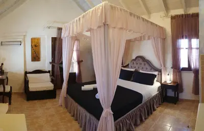 a bedroom with a bed with a canopy at Odos Oneiron Boutique Hotel in Chania Town