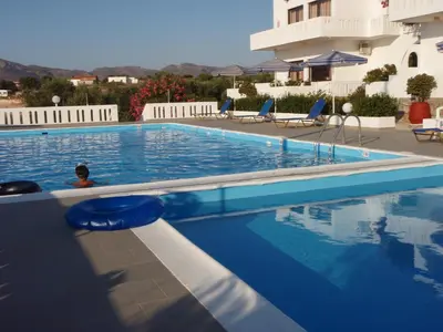 a swimming pool in front of a building at Villas Michalis in Chorafakia