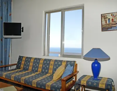 a couch sitting in a living room with a window at Villas Michalis in Chorafakia