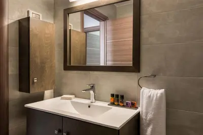 a bathroom with a sink and a mirror at Jasmine in Maleme