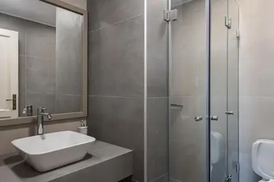 a bathroom with a sink and a shower at Alianthos Suites in Tersanas