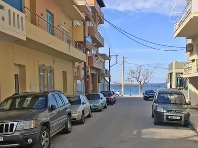 a street with cars parked on the side of a building at Nea Chora Maisonette in Chania Town