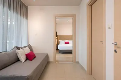 a living room with a couch and a bed at Trianon Luxury Apartments & Suites in Chania Town