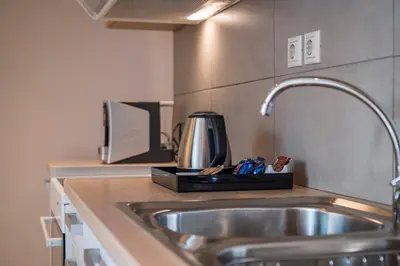 a kitchen counter with a sink and a coffee maker at Trianon Luxury Apartments & Suites in Chania Town