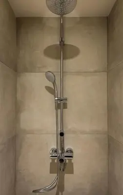 a shower with a shower head in a bathroom at Trianon Luxury Apartments & Suites in Chania Town