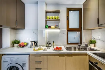 a kitchen with a sink and a washing machine at City Breeze Apartment in Chania Town