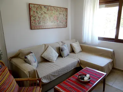 a living room with a couch and a table at Apartment by the Sea in Kato Daratso