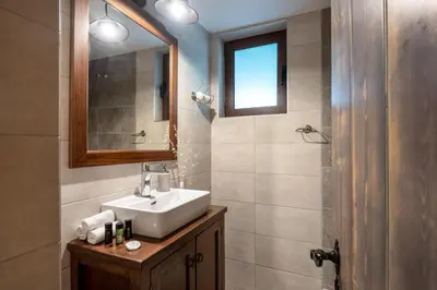 a bathroom with a sink and a mirror at Villa Aerino in Azoyirás