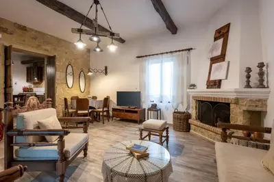 a living room filled with furniture and a fireplace at Villa Aerino in Azoyirás