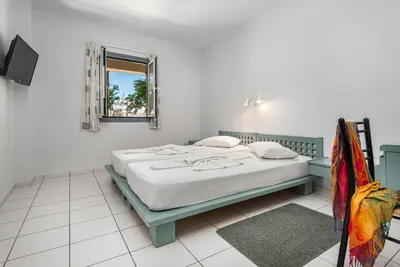 a bedroom with a bed and a mirror at Aphea Village in Kolymvari