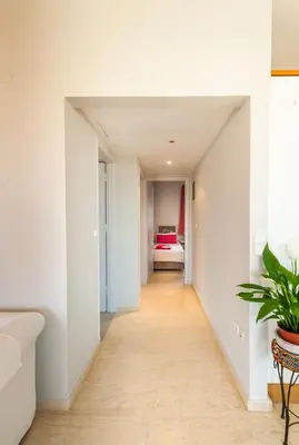 a hallway leading to a bedroom with a bed at Skandalakis Homes & Apartments in Stalos