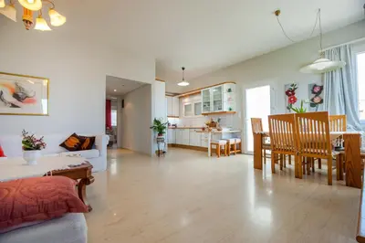 a living room and kitchen with a couch and a table at Skandalakis Homes & Apartments in Stalos