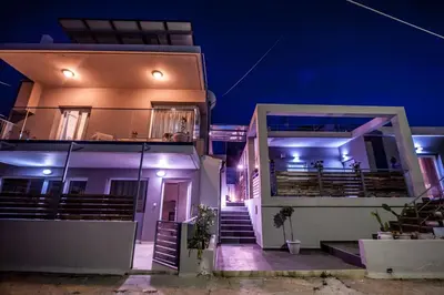 a house with a staircase leading up to it at night at Skandalakis Homes & Apartments in Stalos