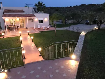 a patio with lights in front of a house at The Well in Chorafakia