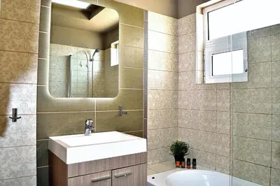 a bathroom with a sink and a mirror at The Well in Chorafakia
