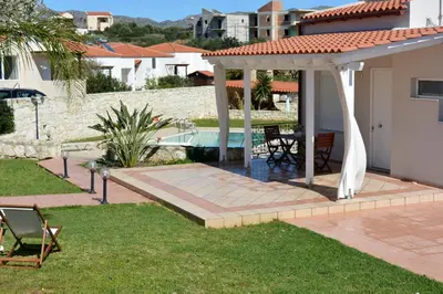 a backyard with a pergola and a swimming pool at The Well in Chorafakia