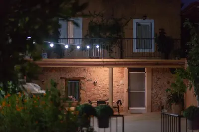 a house with a balcony with lights on it at Casa Arokaria in Pendarianá