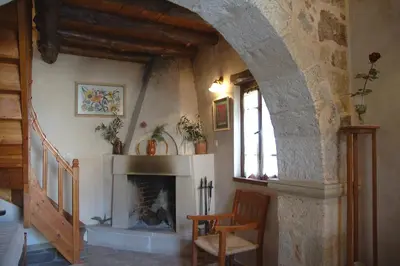 a living room with a fireplace and a chair at Fabrica in Vamos