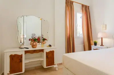 a bedroom with a dressing table with a mirror at Rena House in Kissamos