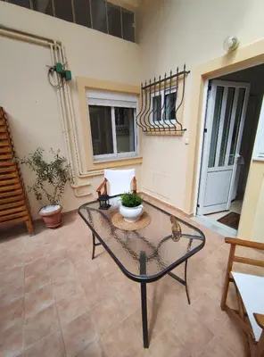 a living room with a glass table in a room at Rena House in Kissamos