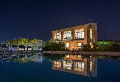 a house on the water at night at Olea Prime in Marathi