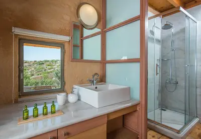 a bathroom with a sink and a glass shower at Olea Prime in Marathi