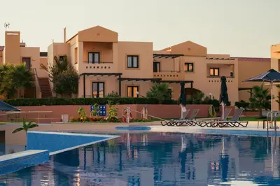 a swimming pool in front of some buildings at Silver Beach Hotel & Apartments in Gerani Chanion