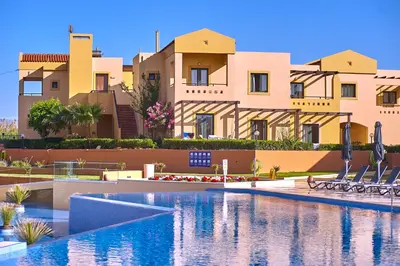 a resort with a swimming pool in front of a building at Silver Beach Hotel & Apartments in Gerani Chanion