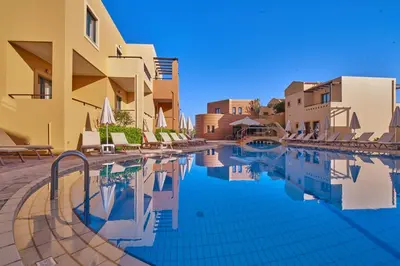 a swimming pool in front of a building at Silver Beach Hotel & Apartments in Gerani Chanion