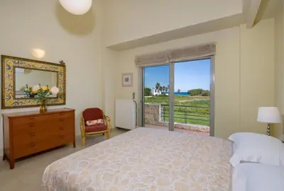 a bedroom with a bed and a large window at Gea Maleme in Maleme
