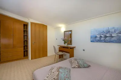 a bedroom with a bed and a desk and a chair at Gea Maleme in Maleme
