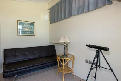 a camera and a couch in a room with a tripod at Gea Maleme in Maleme