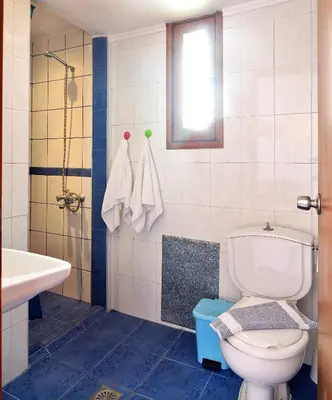 a bathroom with a toilet and a sink at San Antonio Apartments in Kolymvari