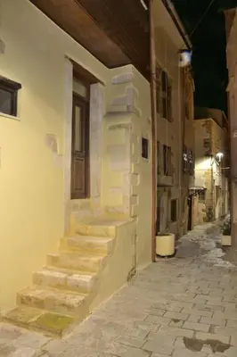 an alley with stairs on the side of a building at Charming stone corner house in Chania Town