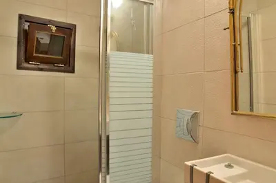 a bathroom with a toilet and a sink and a shower at Charming stone corner house in Chania Town