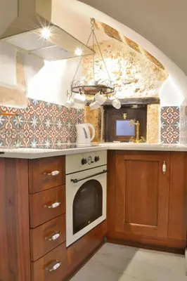 a kitchen with a stove and an oven in it at Charming stone corner house in Chania Town