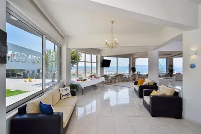 a living room with couches and a dining room at Loucerna Suites Chania in Chania Town