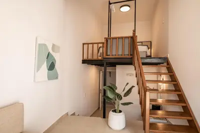 a room with a loft bed and a staircase at Casa Veneta in Chania Town