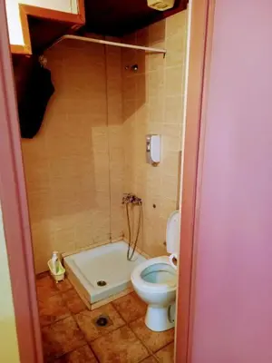 a bathroom with a toilet and a bath tub at Caza Latina in Chania Town