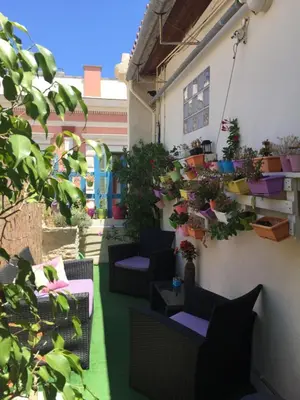 a patio with chairs and potted plants on a building at MmeBassia in Chania Town