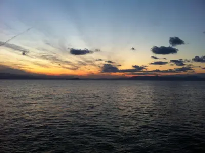 a sunset over the ocean with clouds in the sky at MmeBassia in Chania Town